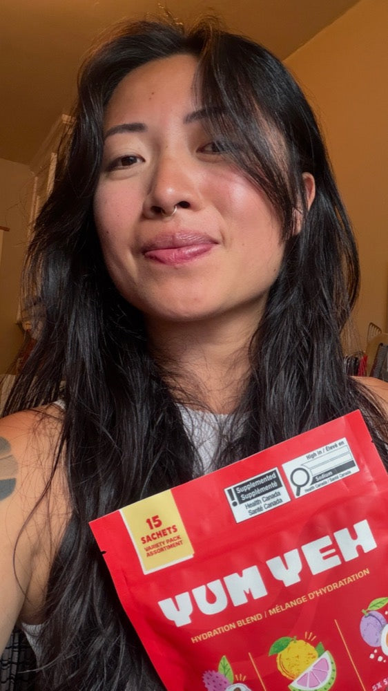 Jennifer, founder of YumYeh, holding the YumYeh variety pack pouch